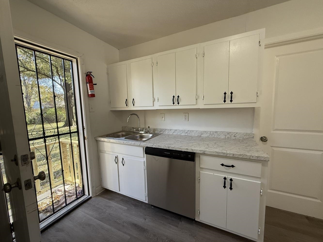 4900 Berta Road Memphis, TN 38109 - Photo 17 of 26 a view of a kitchen with granite countertop cabinets appliances and a wooden floor