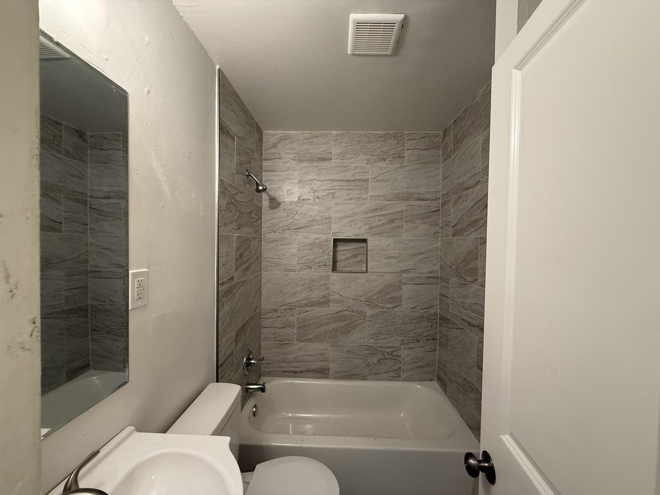 4900 Berta Road Memphis, TN 38109 - Photo 18 of 26 a bathroom with a bathtub and shower