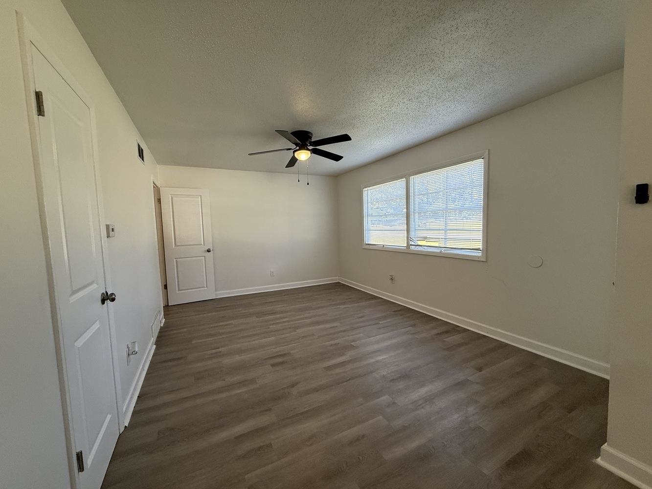4900 Berta Road Memphis, TN 38109 - Photo 8 of 26 wooden floor in an empty room with a window