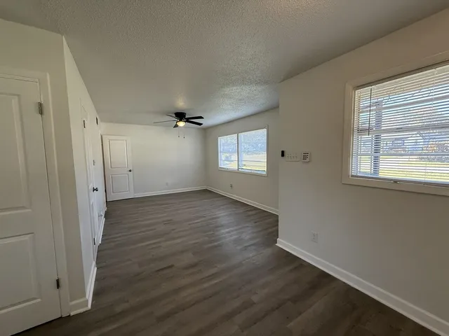 a view of an empty room with a window