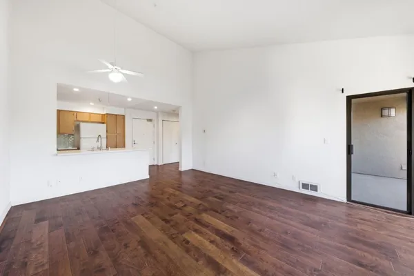 a view of empty room with wooden floor and fireplace