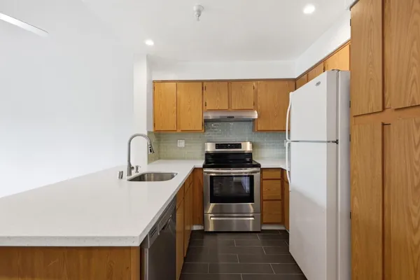 a kitchen with a sink stove and microwave