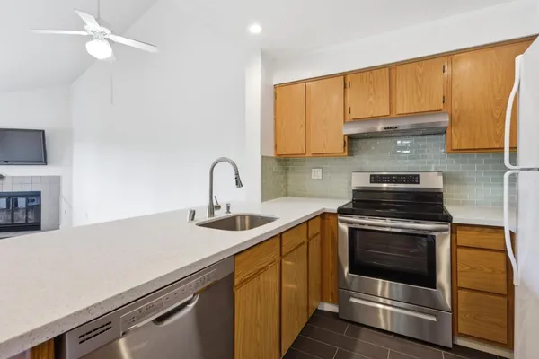 a kitchen with a refrigerator sink and cabinets