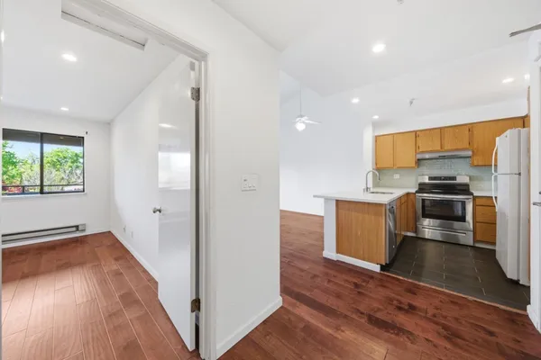 wooden floor in an empty room and a bathroom