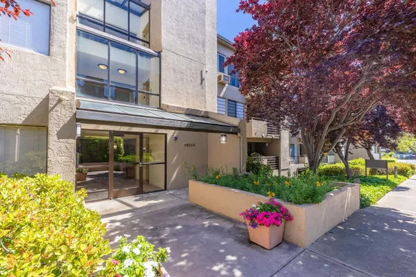 a front view of a building with garden