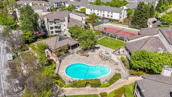 an aerial view of residential houses with outdoor space