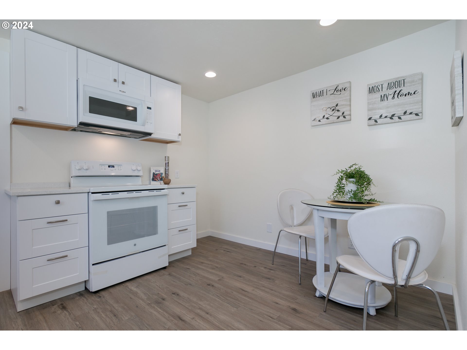 146 South 15th Street Springfield, OR 97477 - Photo 7 of 28 a kitchen with stainless steel appliances a white table and chair