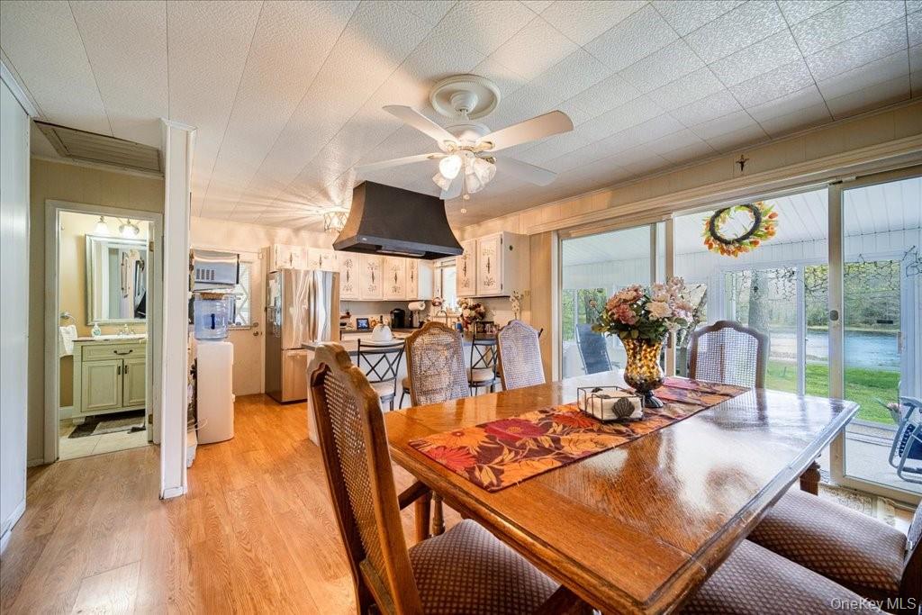 307 Beaver Lake Road Livingston Manor, NY 12758 - Photo 17 of 36 a view of a dining room with furniture a chandelier and large windows
