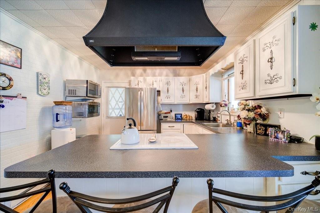 307 Beaver Lake Road Livingston Manor, NY 12758 - Photo 19 of 36 a kitchen with a dining table chairs and a refrigerator