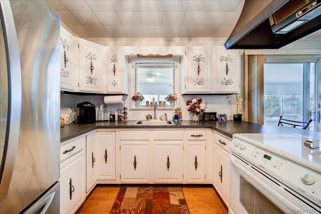 307 Beaver Lake Road Livingston Manor, NY 12758 - Photo 20 of 36 a kitchen with white cabinets and sink