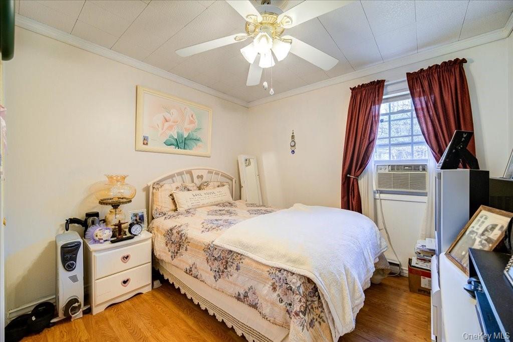 307 Beaver Lake Road Livingston Manor, NY 12758 - Photo 26 of 36 a bedroom with a bed and a chandelier