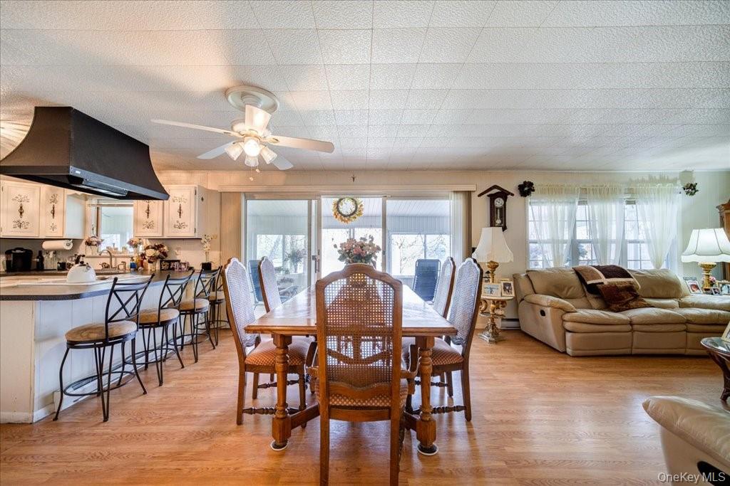 307 Beaver Lake Road Livingston Manor, NY 12758 - Photo 9 of 36 a view of a dining room with furniture window and wooden floor
