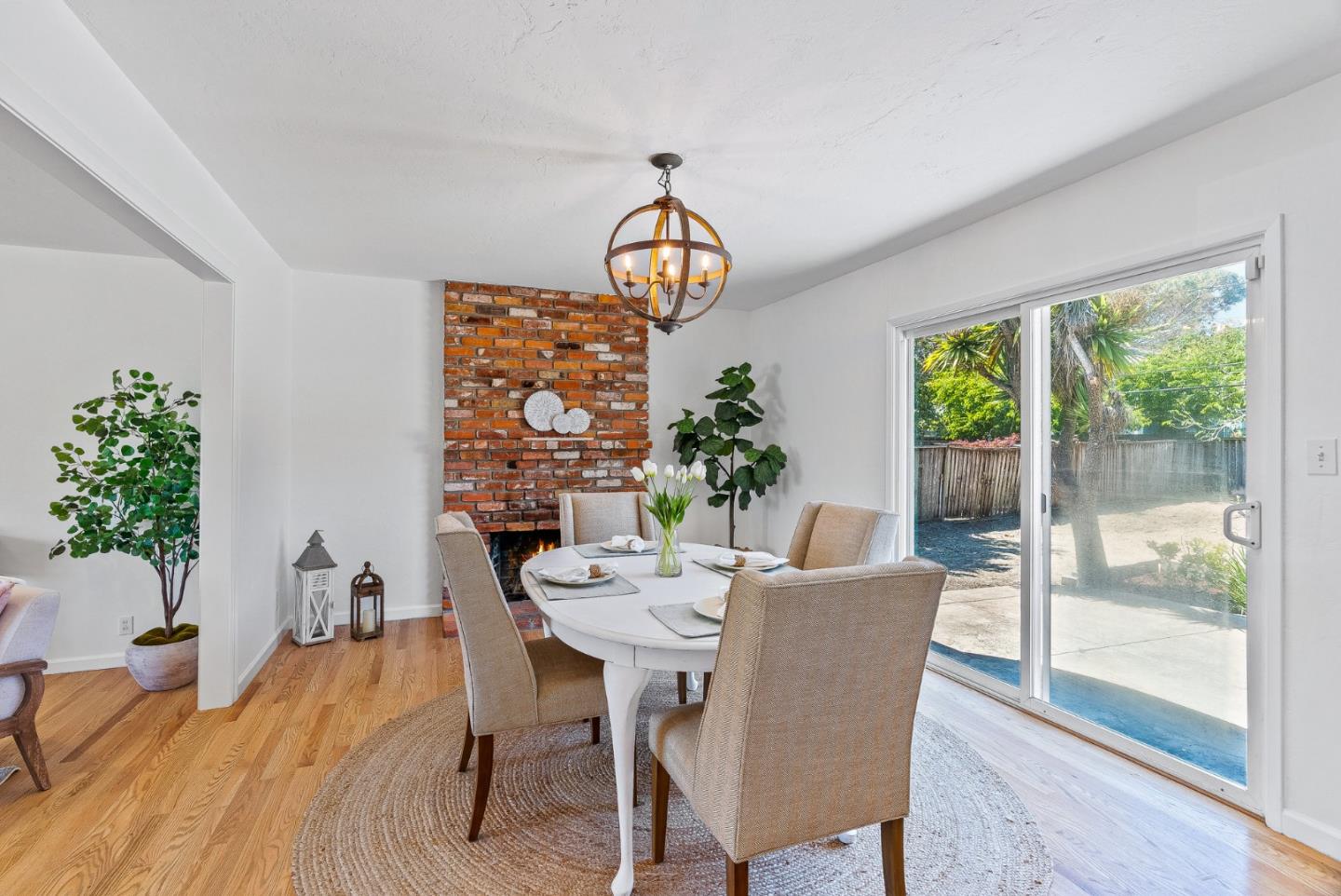 829 Monterey Avenue Capitola, CA 95010 - Photo 14 of 59 a dining room with furniture potted plants and wooden floor