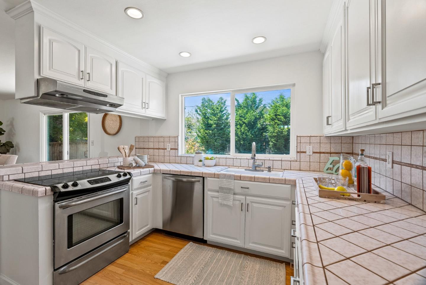 829 Monterey Avenue Capitola, CA 95010 - Photo 17 of 59 a kitchen with stainless steel appliances a stove a white cabinets and a sink