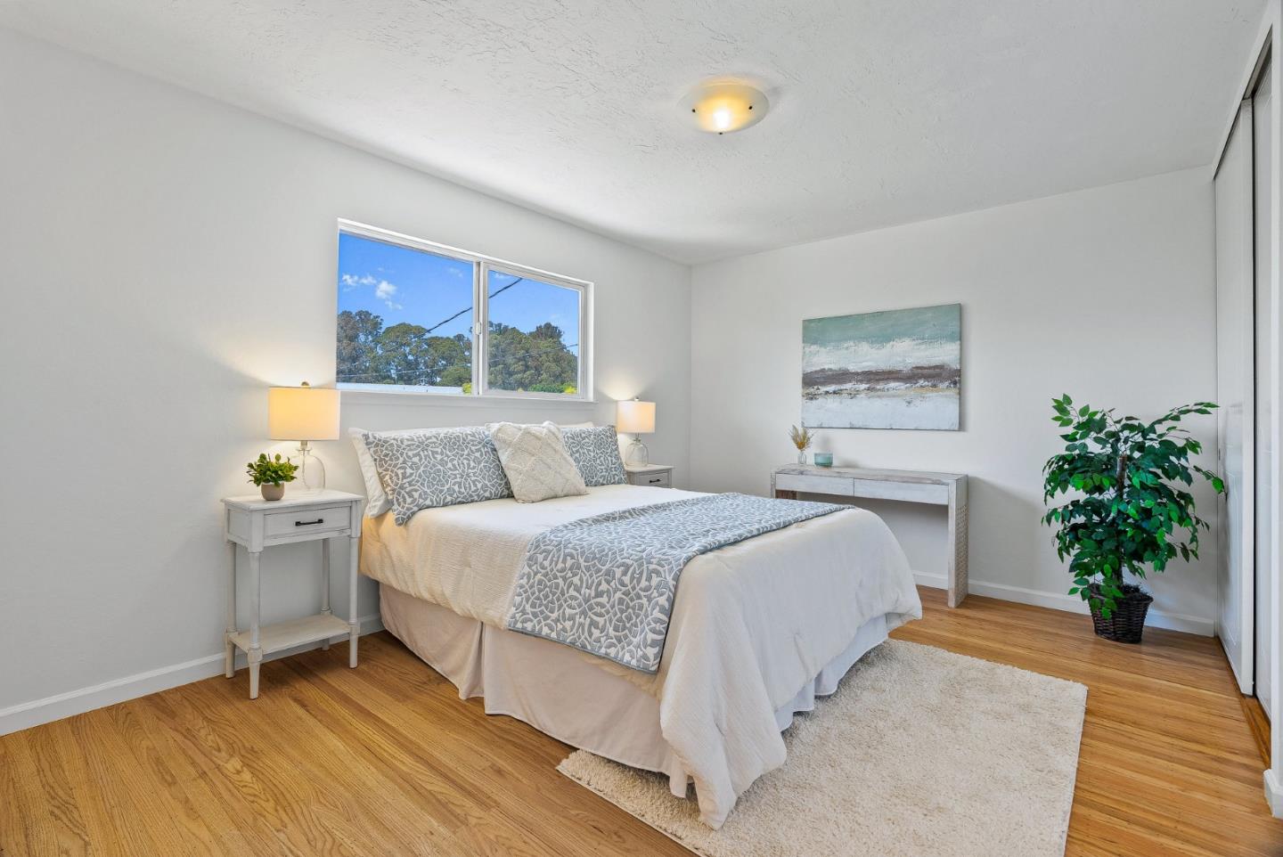 829 Monterey Avenue Capitola, CA 95010 - Photo 21 of 59 a bedroom with a bed and a potted plant