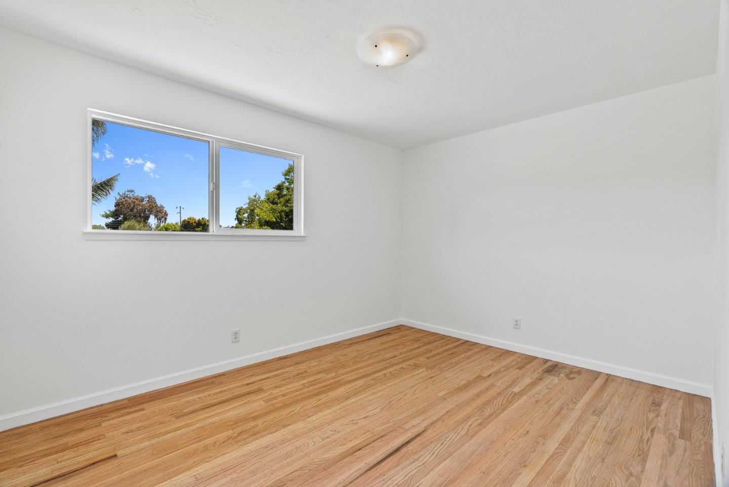 829 Monterey Avenue Capitola, CA 95010 - Photo 25 of 59 a view of empty room with wooden floor and fan