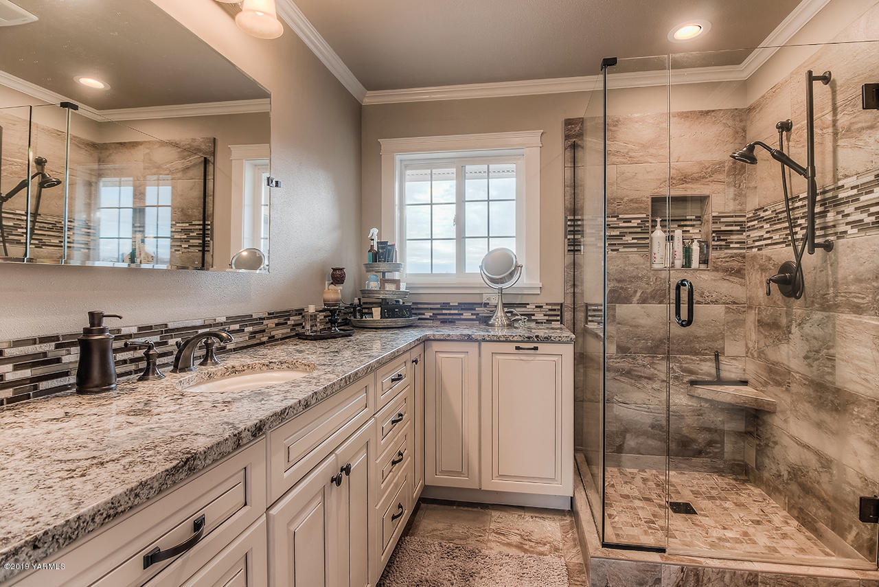 852 Clark Road Zillah, WA 98953 - Photo 22 of 55 a bathroom with a granite countertop sink a mirror and shower