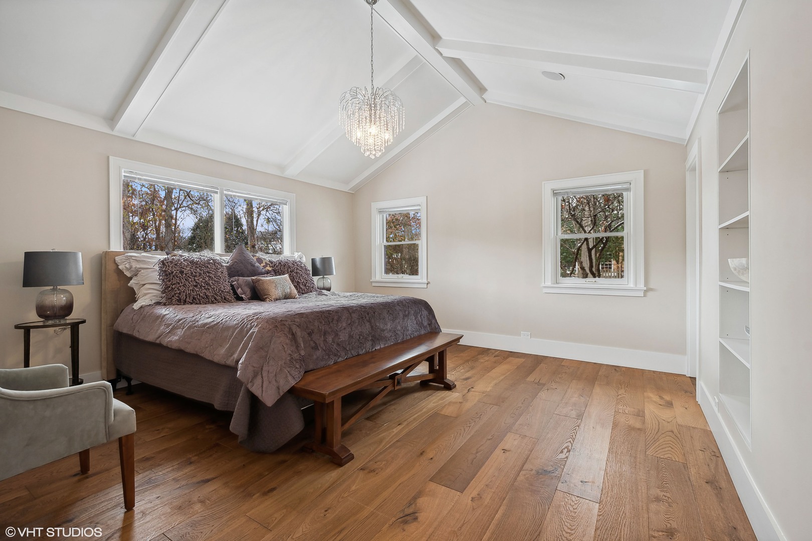 526 Coronet Road Glenview, IL 60025 - Photo 17 of 23 a bedroom with a large bed a chandelier and windows