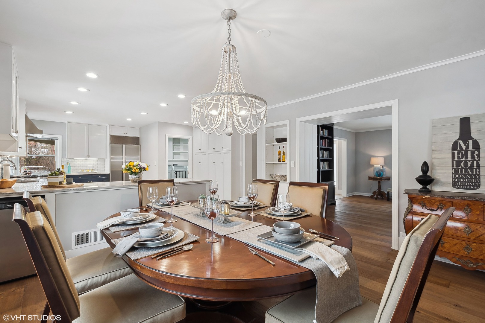 526 Coronet Road Glenview, IL 60025 - Photo 7 of 23 a view of a dining room and livingroom with furniture wooden floor and a chandelier