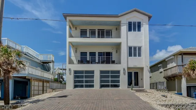 a view of a house with a yard and more windows