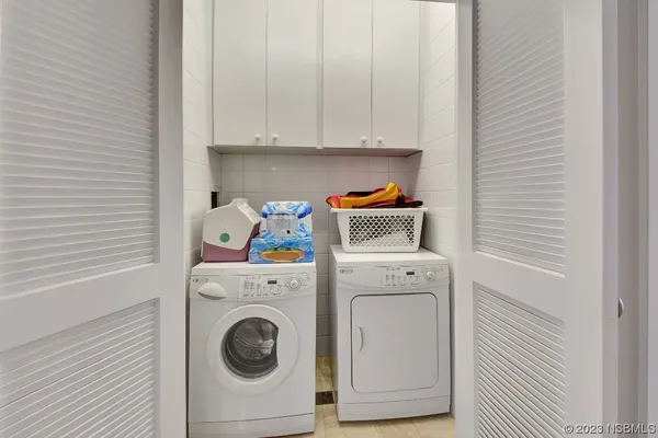 a living room with furniture and a dining table with wooden floor