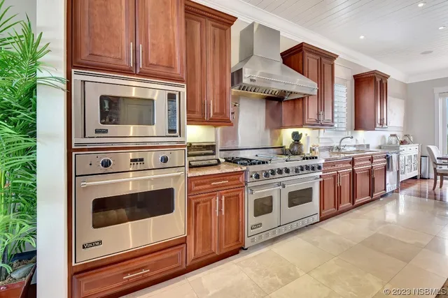a kitchen with stainless steel appliances granite countertop a sink and cabinets