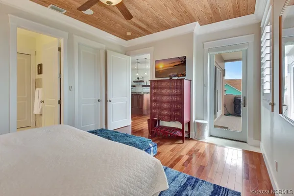 a bedroom with a bed and a flat tv screen