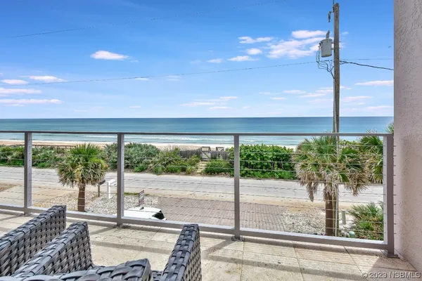 a view of a livingroom with furniture and a kitchen