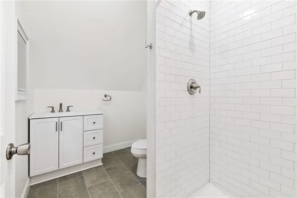 a bathroom with a toilet sink and shower