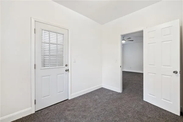 an empty room with windows and closet