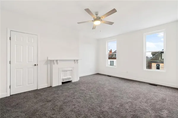 an empty room with a empty space and windows