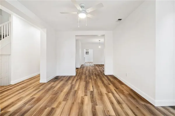 a view of a bedroom with wooden floor