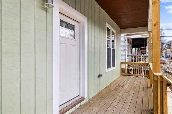 a view of a house with deck and a patio