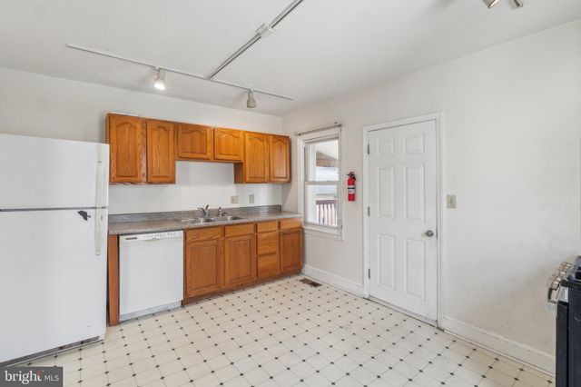 a kitchen with stainless steel appliances a refrigerator and cabinets