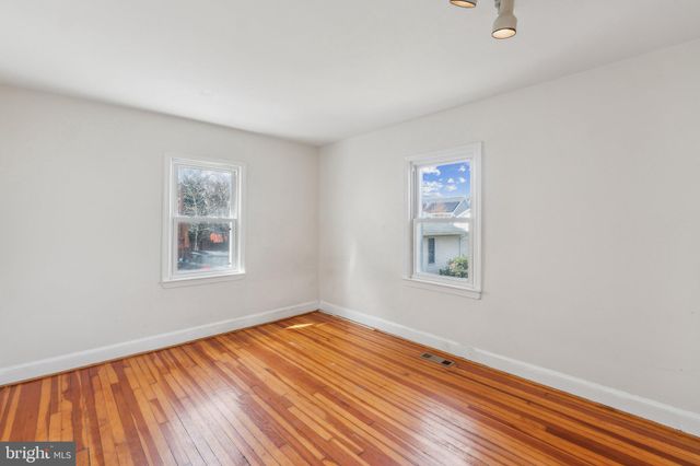 a view of a room with wooden floor and window