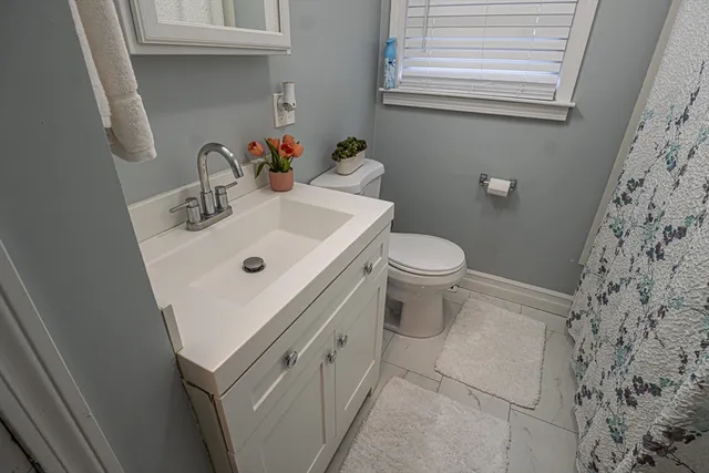 a white sink sitting next to a white toilet