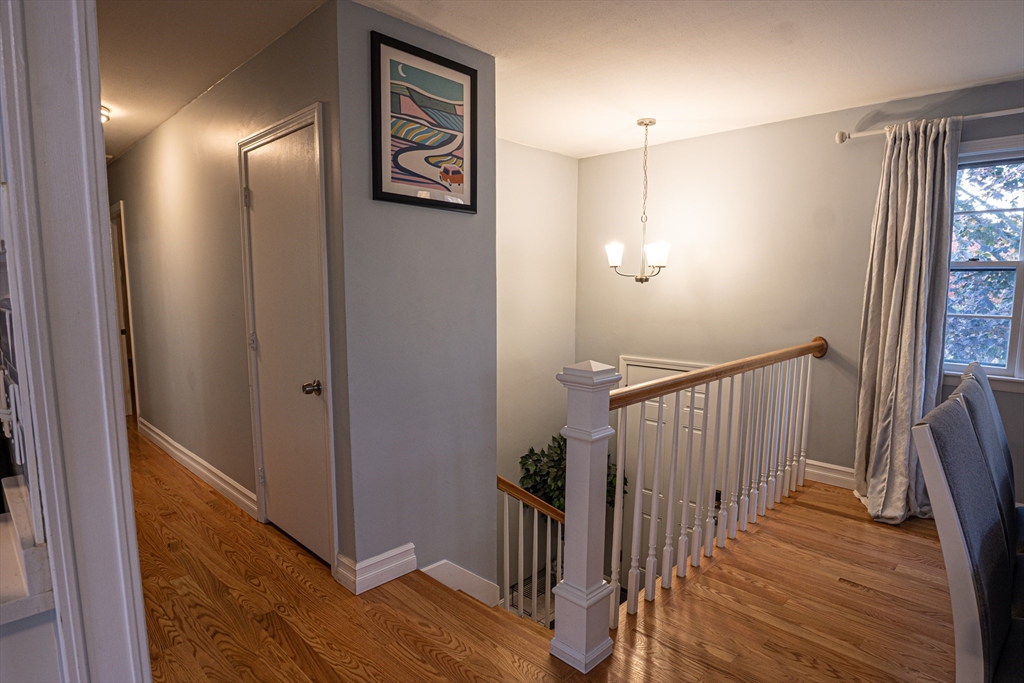 5 Bailey Road Dracut, MA 01826 - Photo 4 of 26 a view of a hallway with wooden floor and staircase