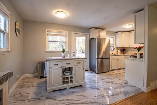 a kitchen with a refrigerator sink and cabinets