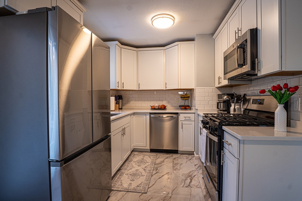 5 Bailey Road Dracut, MA 01826 - Photo 8 of 26 a kitchen with stainless steel appliances granite countertop a refrigerator sink and stove