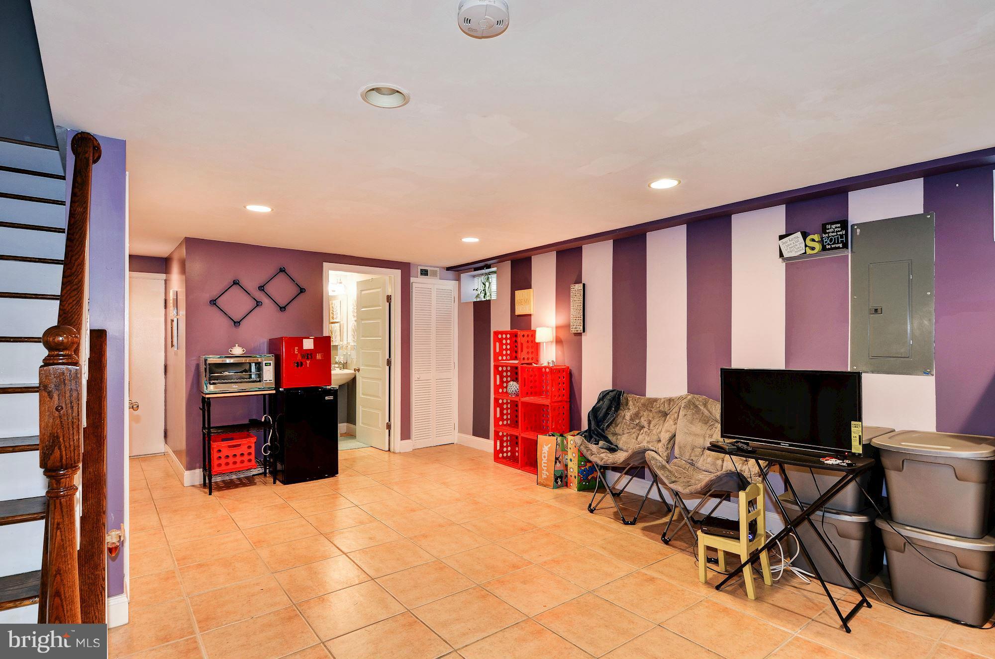 716 Roxboro Place Northwest Washington, DC 20011 - Photo 22 of 25 a bed room with a bed and a flat screen tv