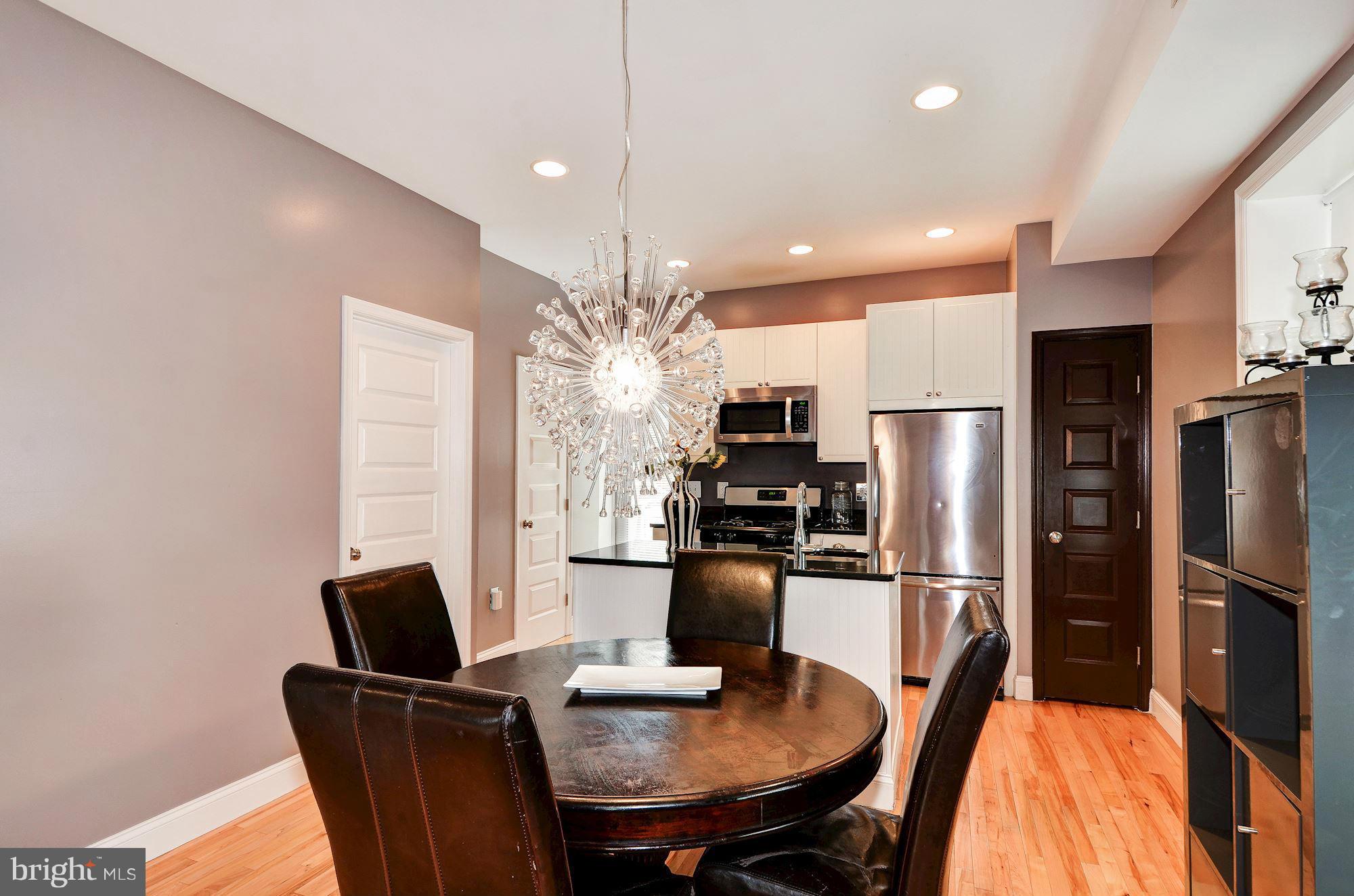 716 Roxboro Place Northwest Washington, DC 20011 - Photo 8 of 25 a kitchen with refrigerator cabinets dining table and chairs