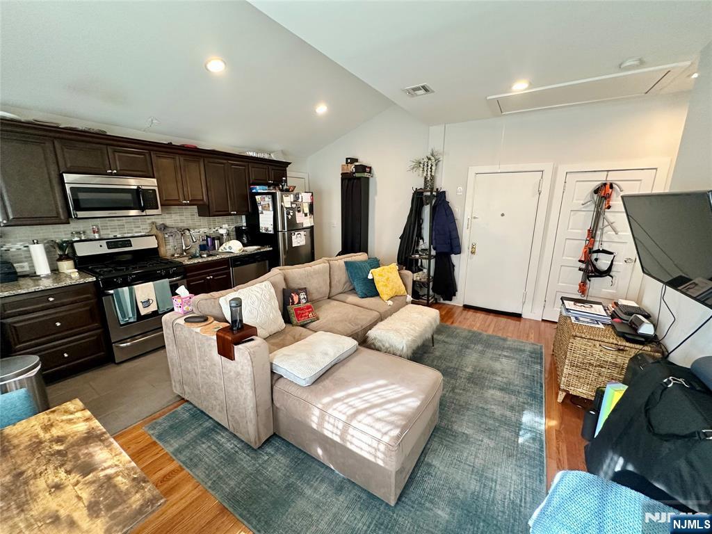 390-apt 4 Orange Road, Unit 4 Montclair, NJ 07042 - Photo 3 of 12 a living room with furniture gym equipment and a flat screen tv