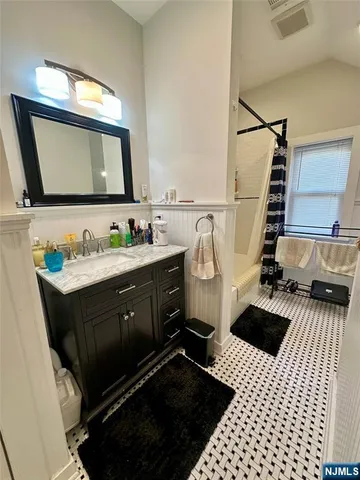 a bathroom with a sink vanity and mirror