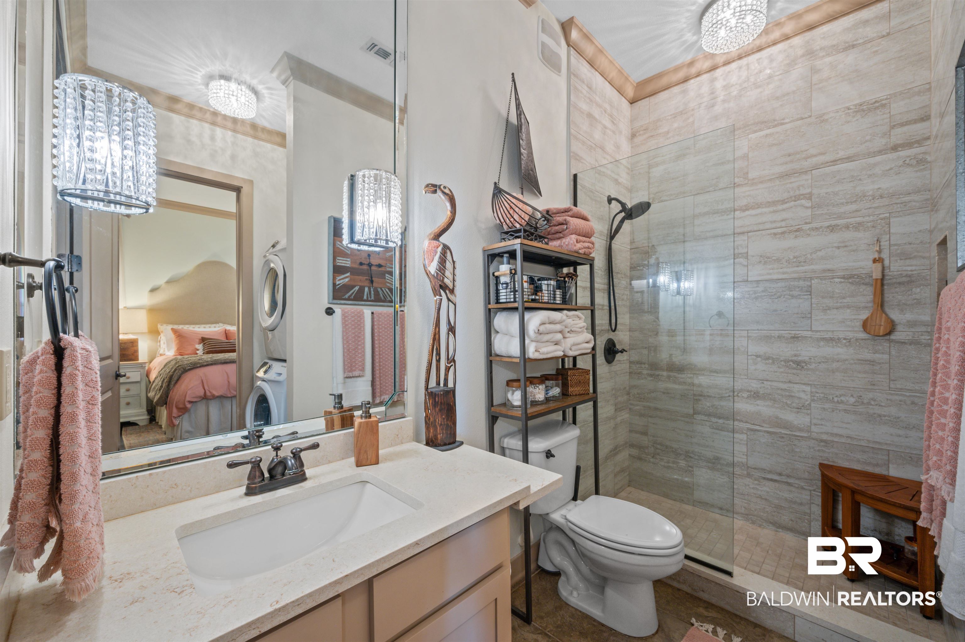 1430 Regency Road, Unit B202 Gulf Shores, AL 36542 - Photo 15 of 33 Full bath featuring toilet, ensuite bathroom, stacked washer / dryer, vanity, and tiled shower