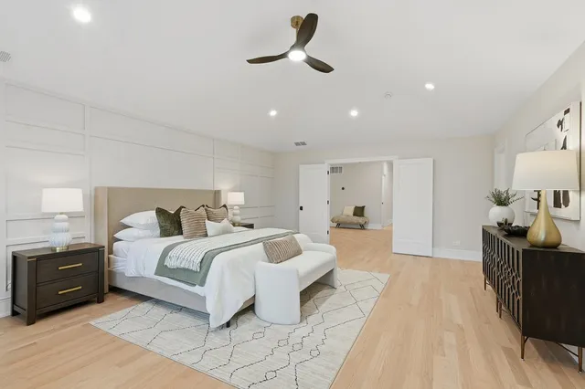 a spacious bedroom with a bed and furniture