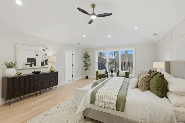 a bedroom with a large bed and a window