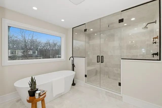 a bathroom with a bathtub and a shower