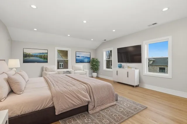 a bedroom with bed tv and window