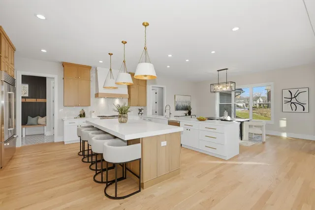 a kitchen with granite countertop a table chairs stove and cabinets