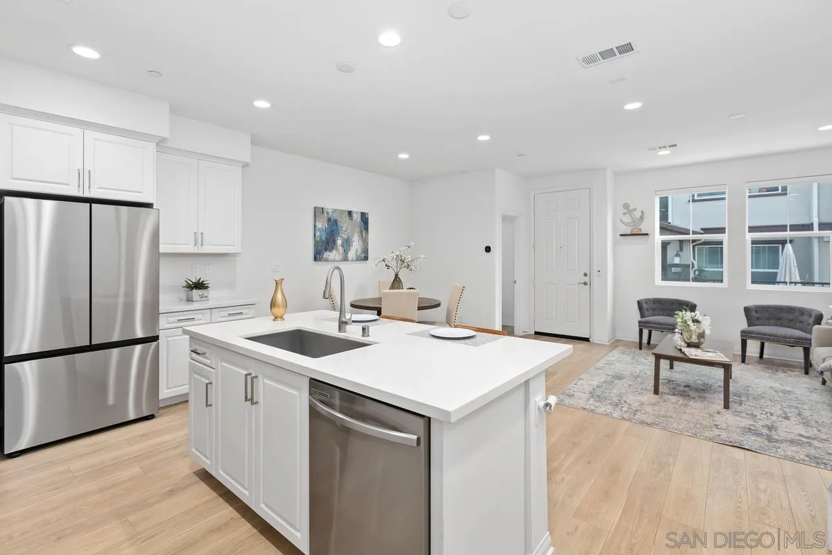 10149 Graphite Street Spring Valley, CA 91977 - Photo 12 of 35 a kitchen that has a sink a table and chairs in it